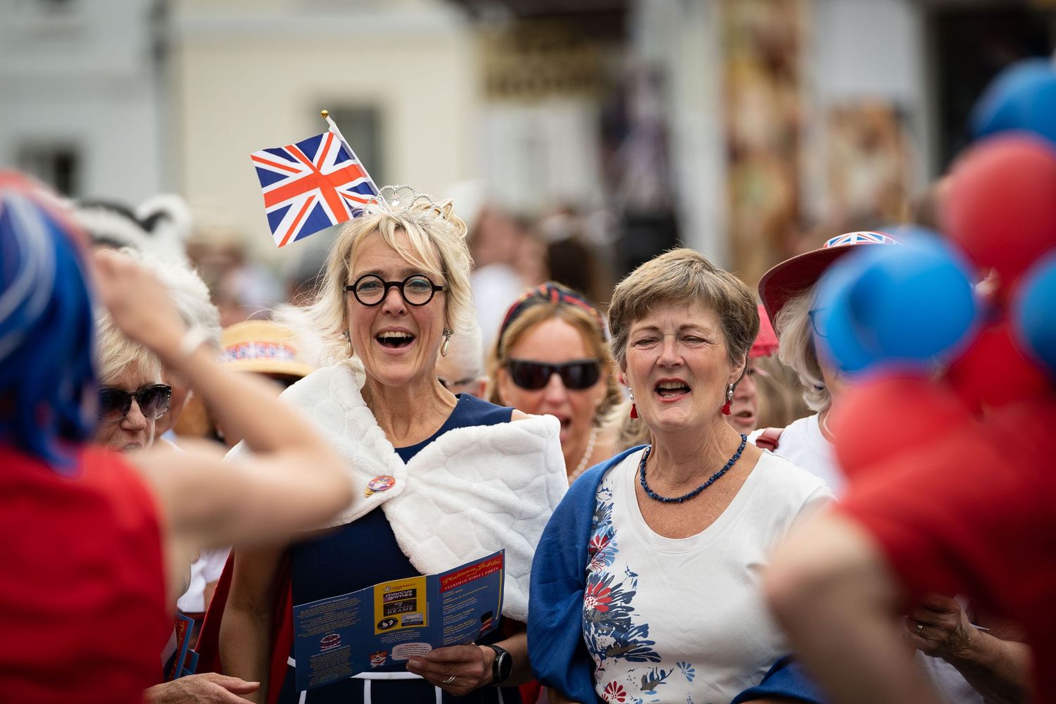 women in union jack dresses at a street party