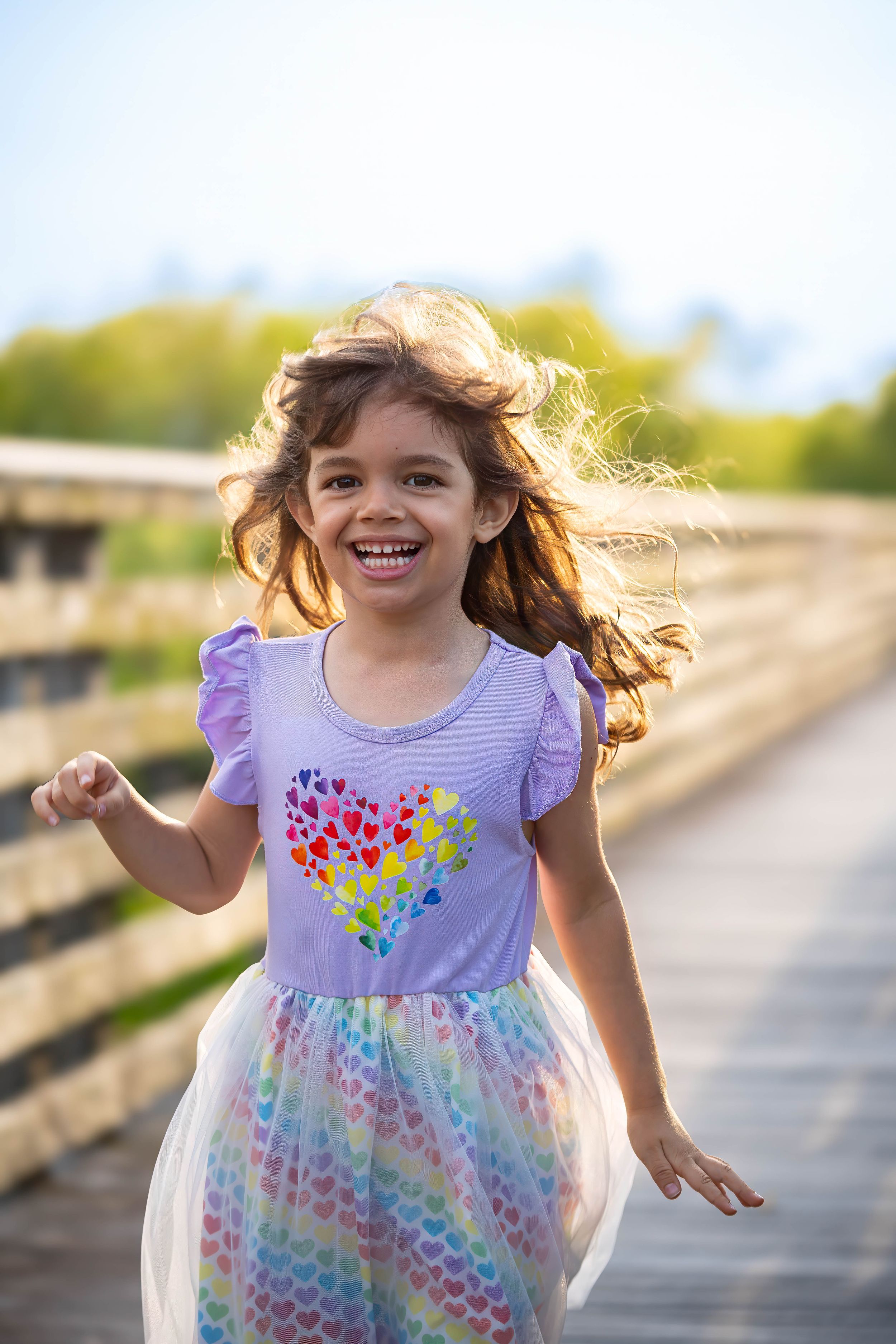evelyn playing on the boardwalk of juno dunes natural area during a family session in juno beach florida