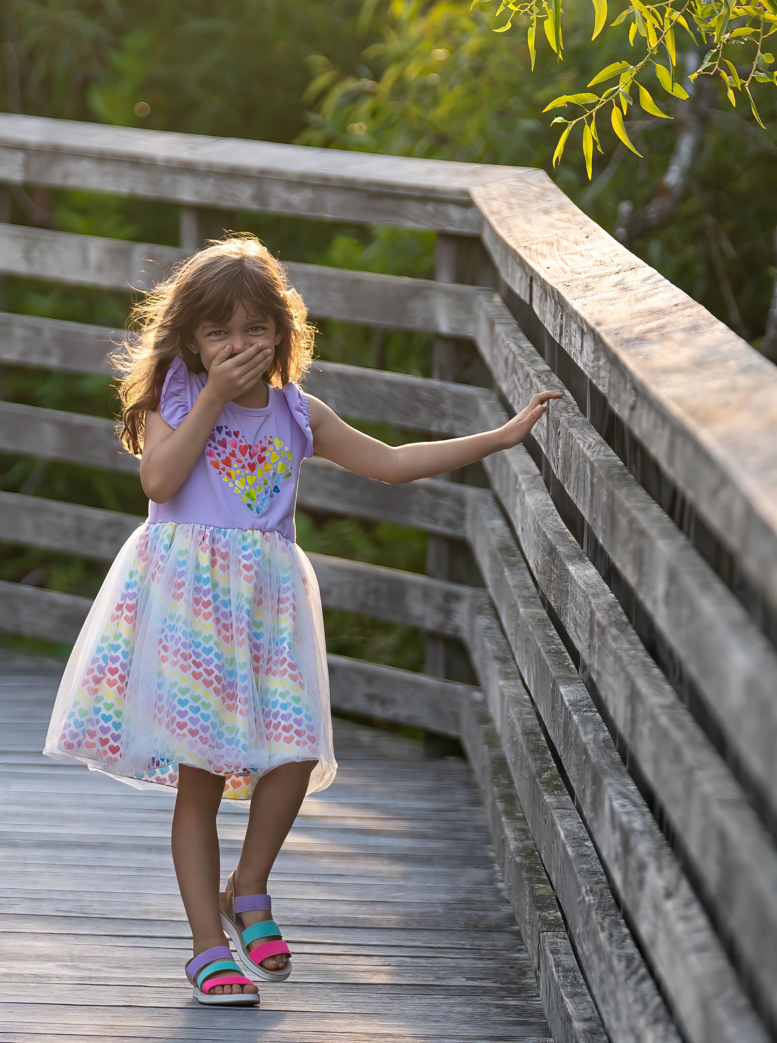 evelyn playing on the boardwalk of juno dunes natural area during a family session in juno beach florida