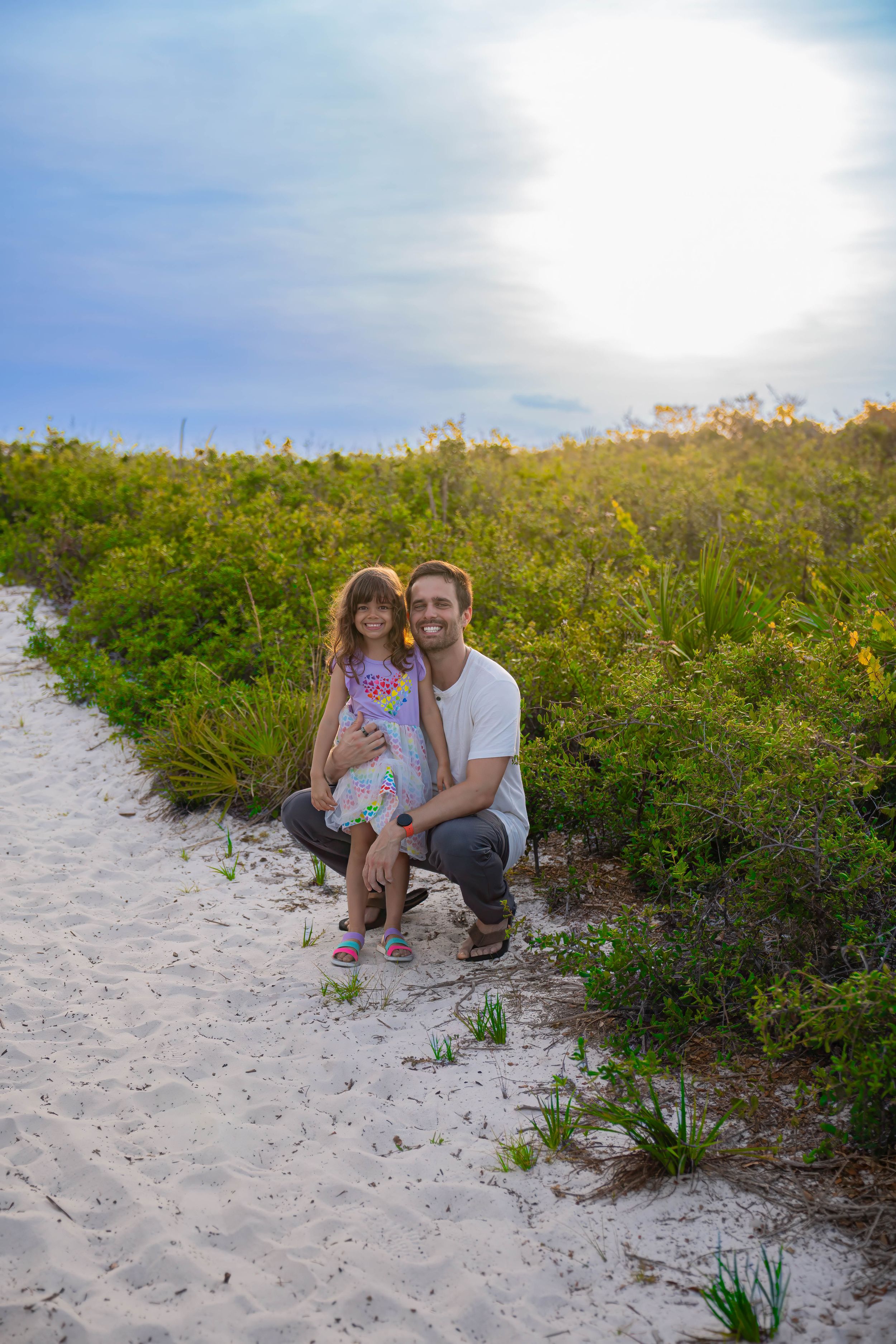 Connor Strzelewicz/Connor Michael Photography posing with evelyn pacheco during a family session in juno dunes natural area of juno beach FL