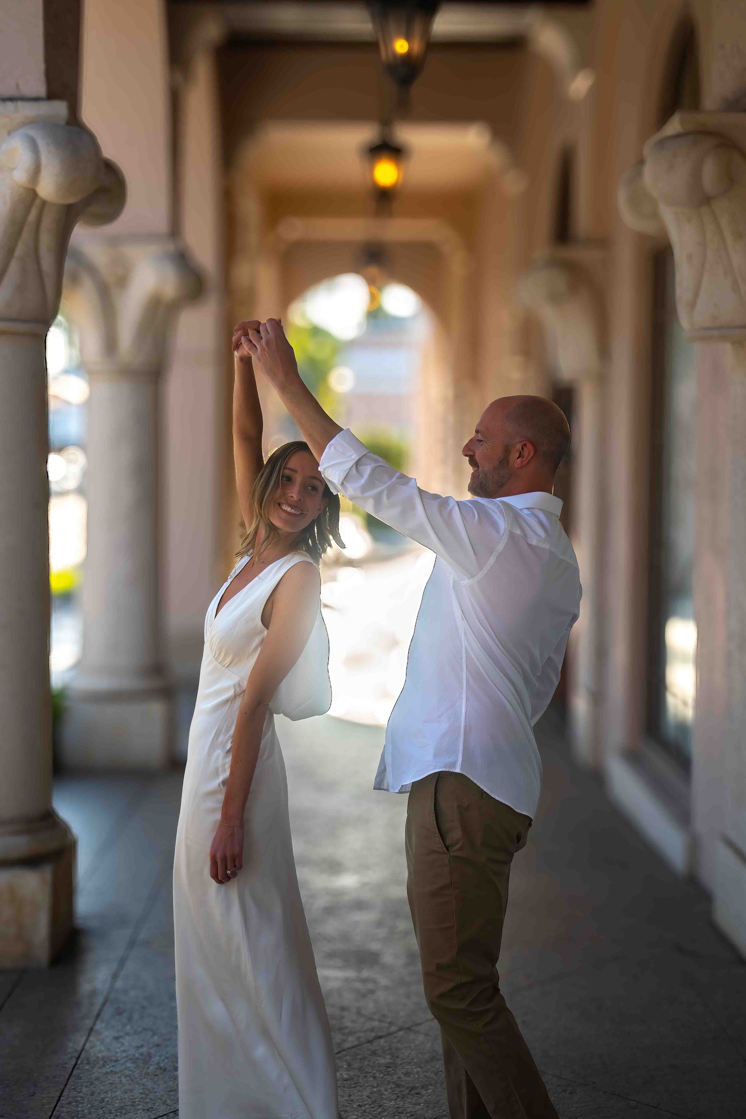 Kari and Jeff standing in worth ave, west palm beach florida, during an engagement couples session