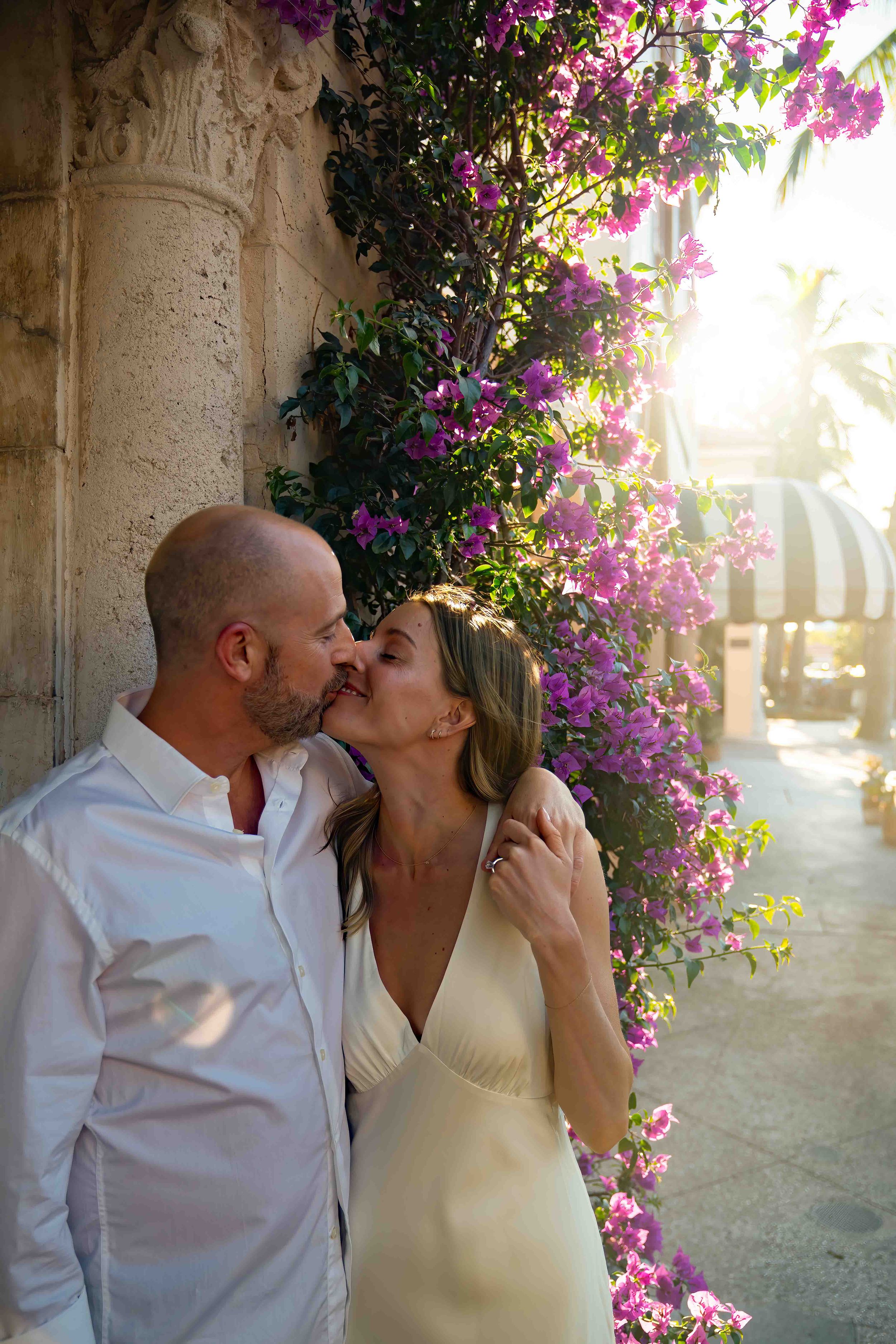Kari and Jeff standing in worth ave, west palm beach florida, during an engagement couples session