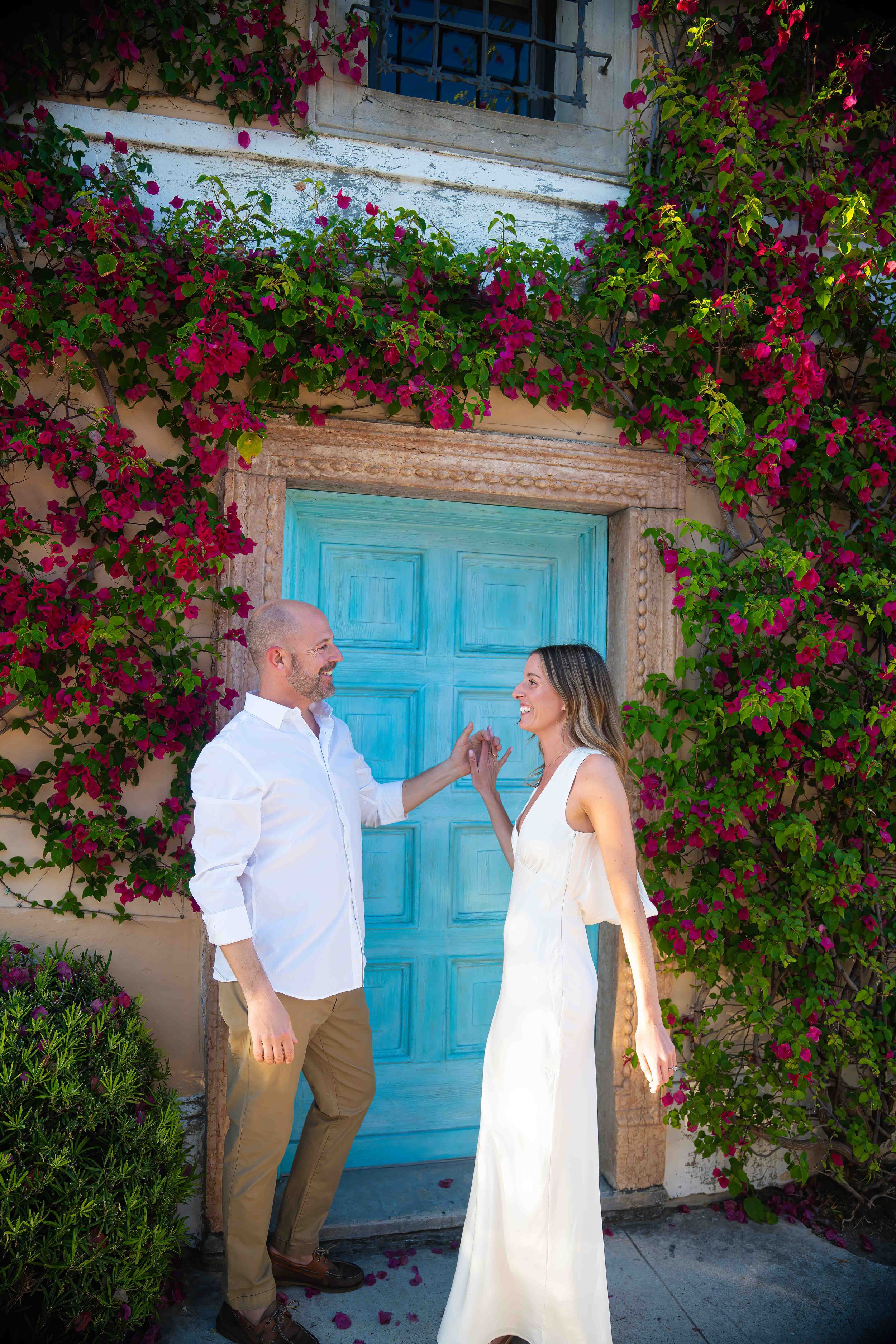 Kari and Jeff standing in worth ave, west palm beach florida, during an engagement couples session