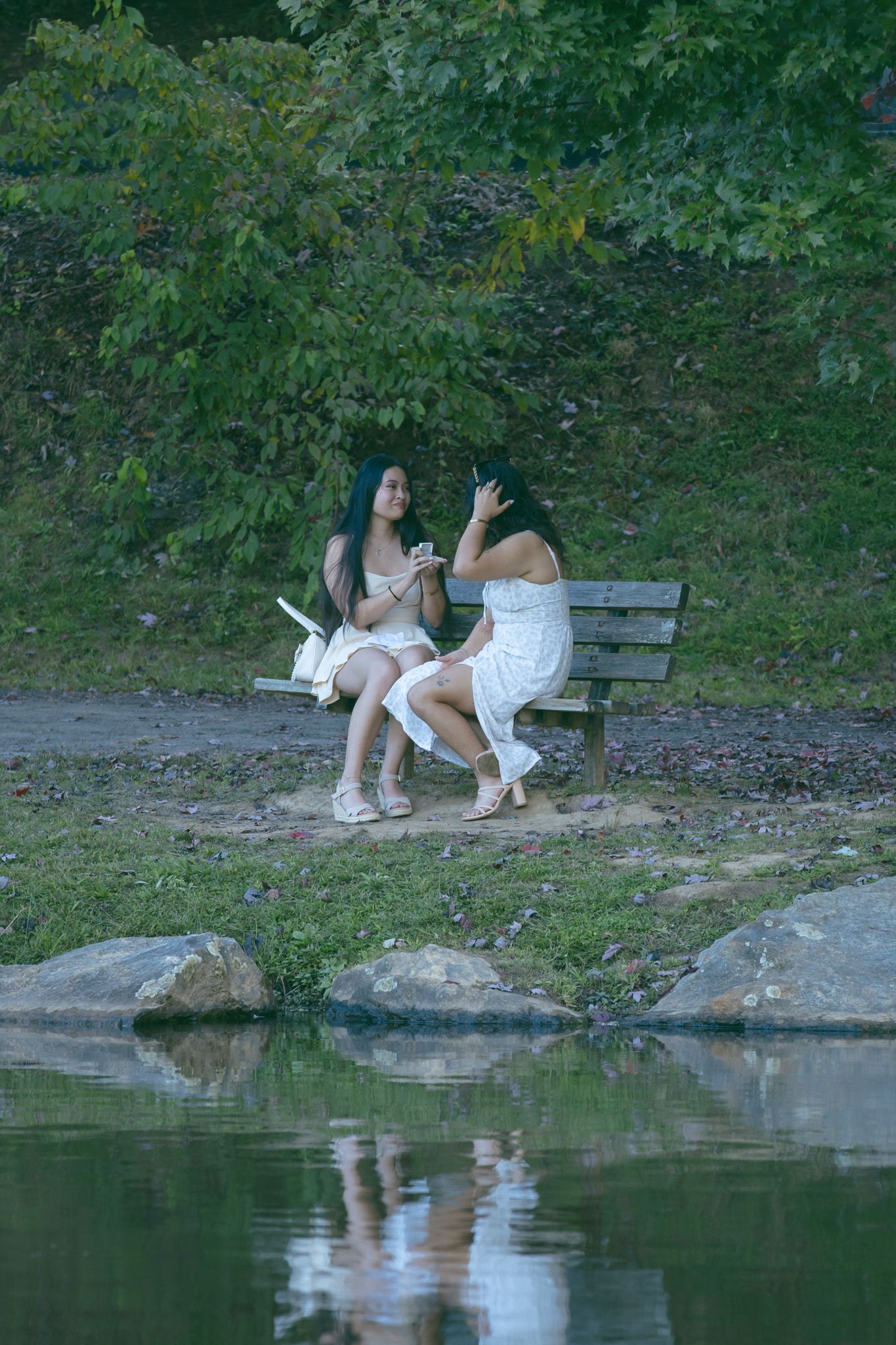 LGBTQ couple holding hands after romantic proposal at blue ridge mountain overlook near Asheville, North Carolina