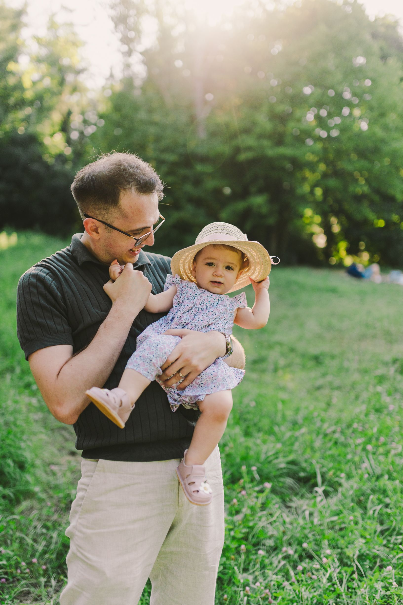 Sweet moments between parent and child in sunny outdoor setting.