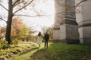 A sequence of five autumn landscape photos showing people walking near stone architecture in golden sunlight.