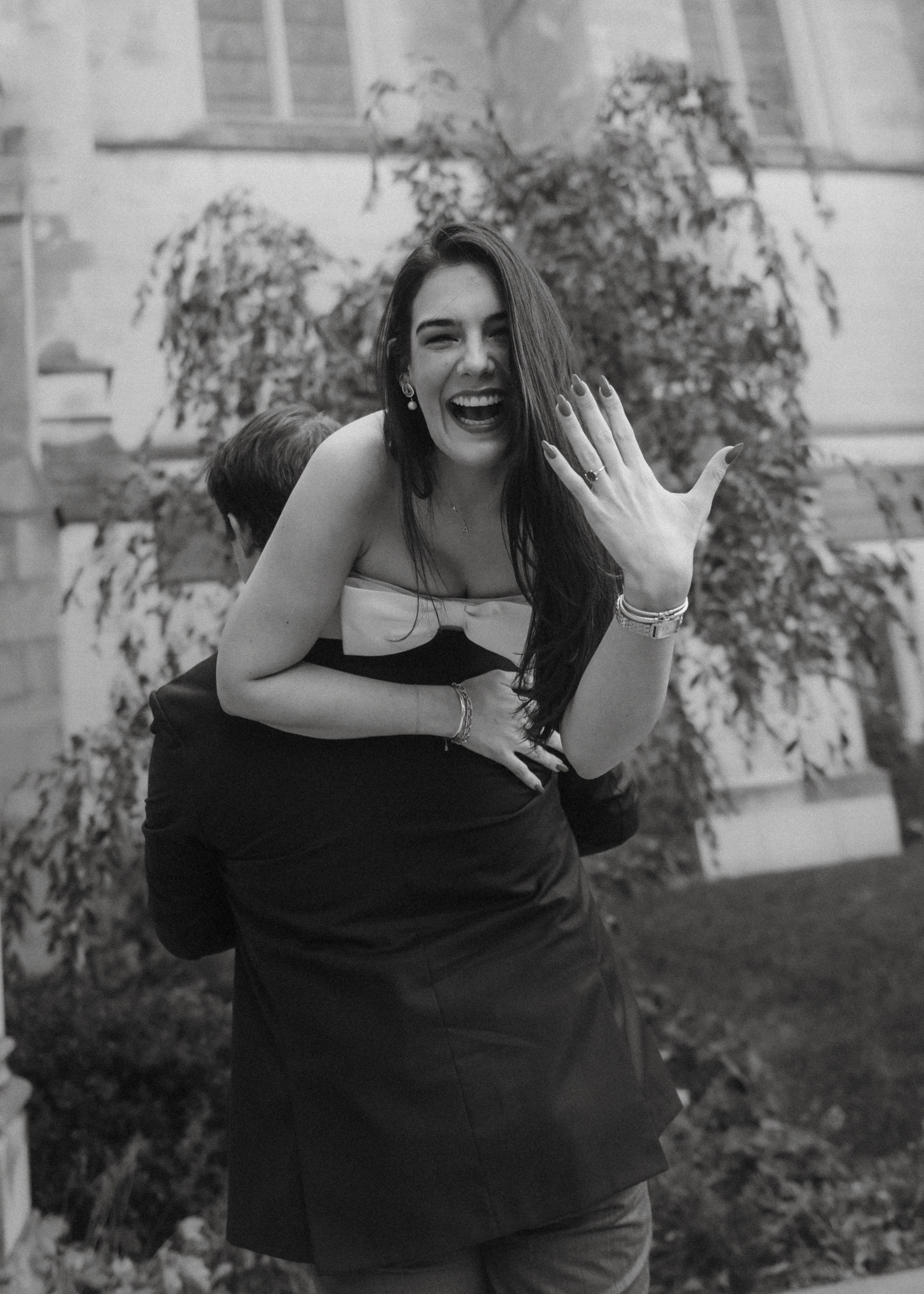 A series of playful black and white photos showing someone in a black dress making expressive poses outdoors.