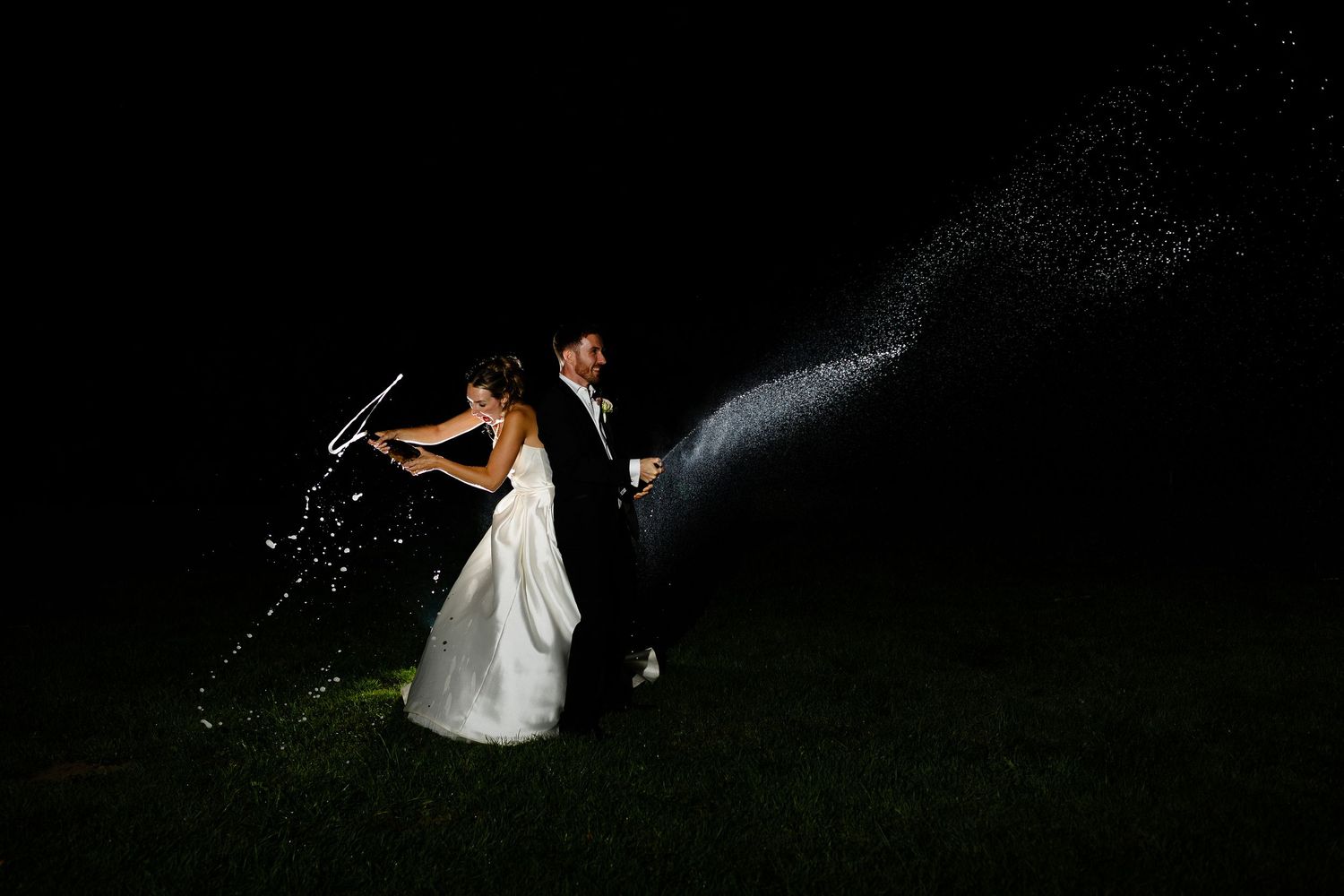 A dark silhouette of a couple embracing in a romantic pose against a night sky background.
