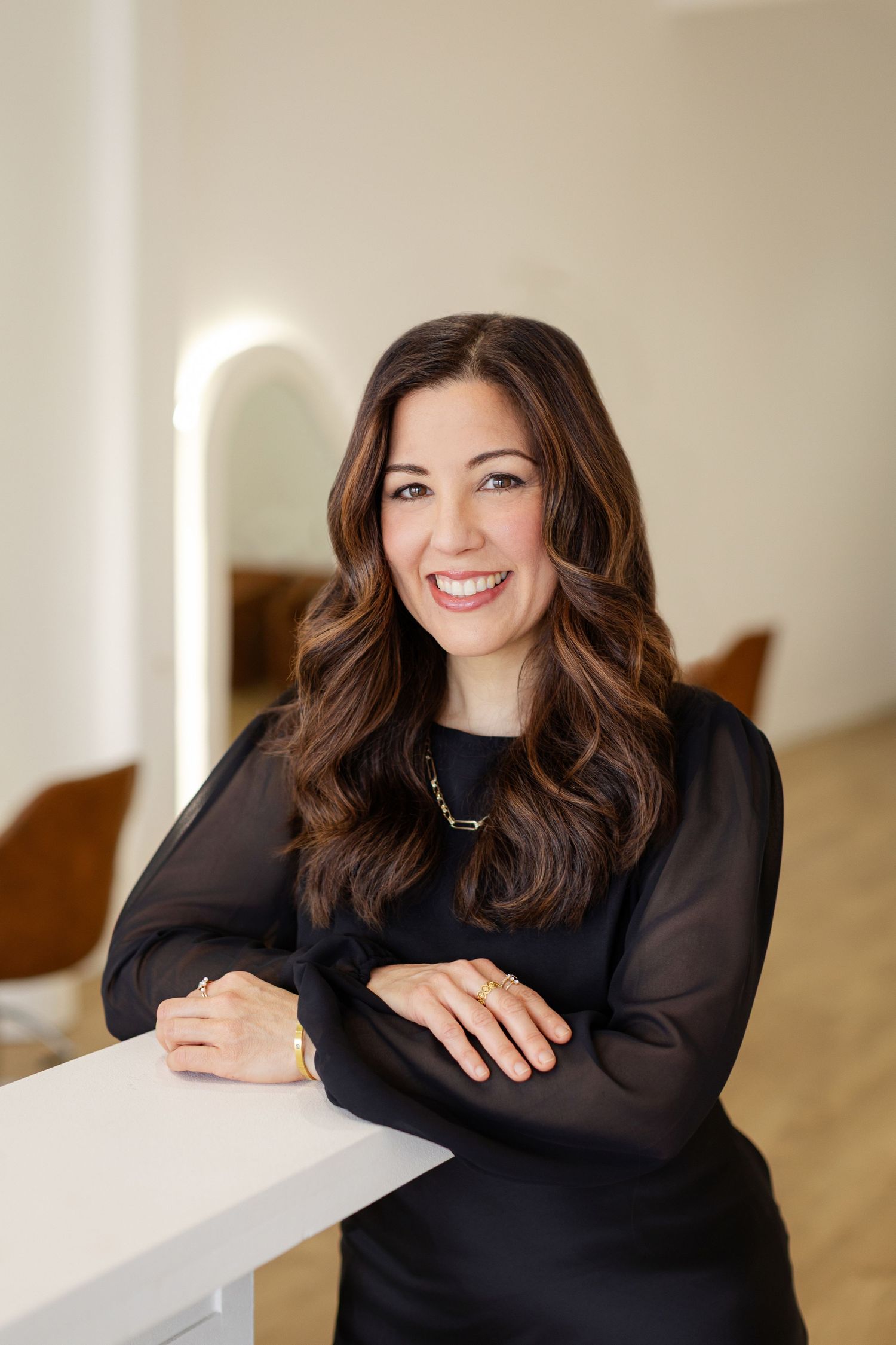 Professional headshots showing warm smiles against a neutral beige background mobile photography studio Kirsten Graham