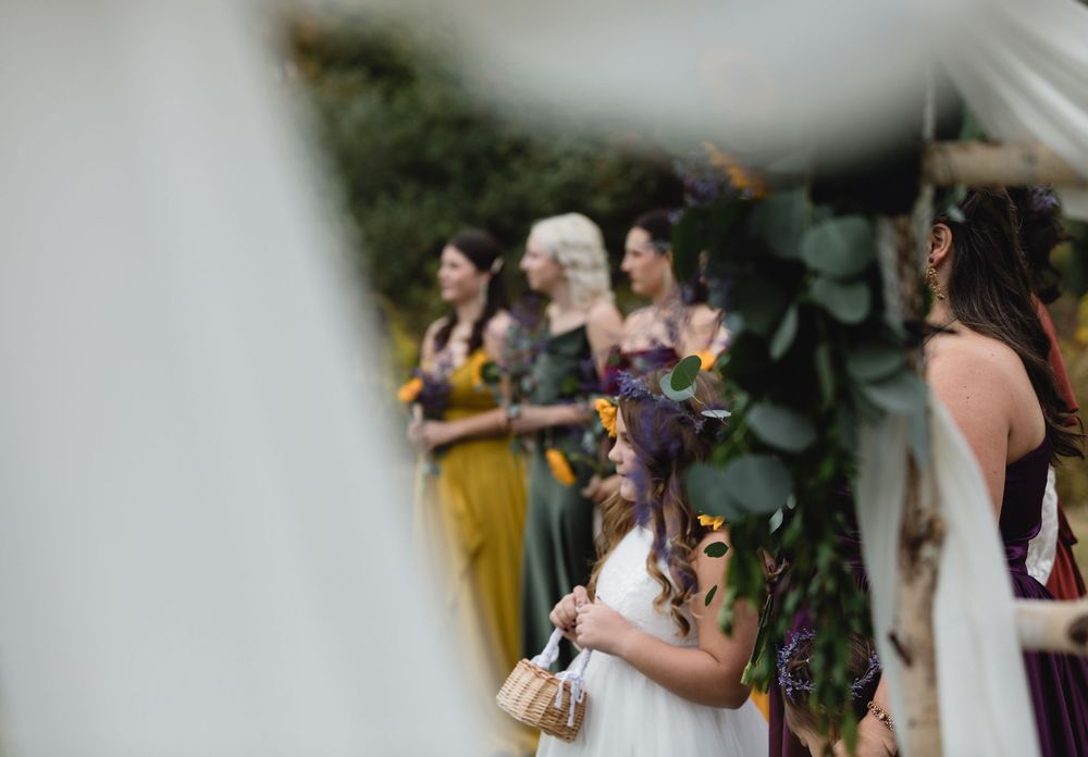 A flower girl is focused on under tulle during a wedding ceremony in southern New Hampshire. Wedding photographer Vermont, Berkshires