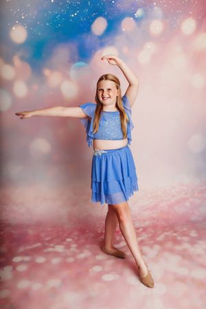 child in blue dress dancing with glitter background smiling up at camera

Best children's photographer, Central Peoria, IL.
