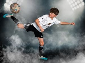 Child kicking a soccer ball into the air with smoke background

Best creative sports photographer, Central Peoria, IL.