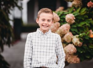 Small child smiling into camera with flowers in the background

Best child photographer, Peoria, IL.