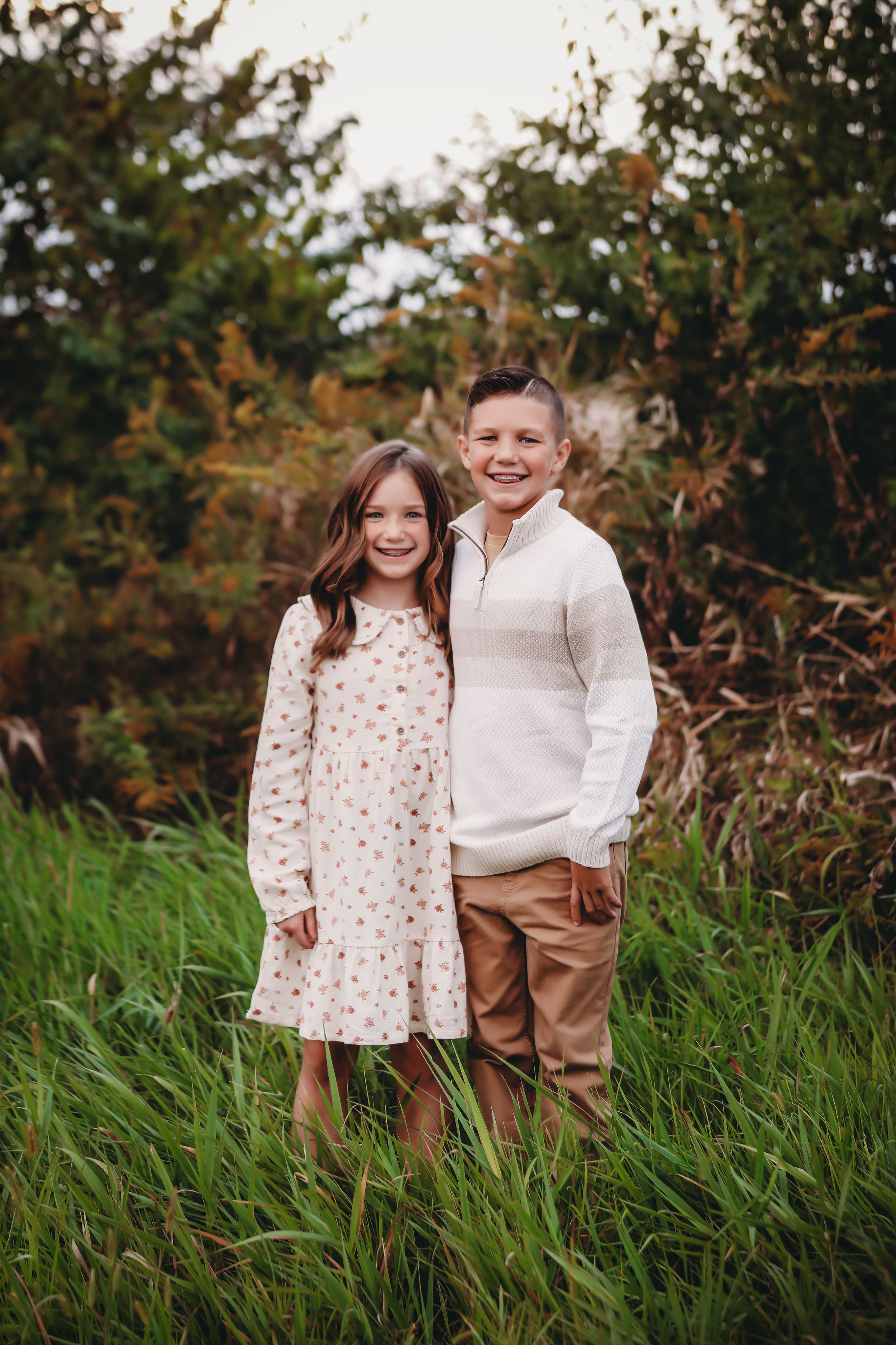 Two children hugging while smiling at camera in tall grass

Best child photographer, Peoria, IL.