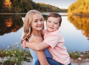 Autumn lakeside portrait session with warm golden sunlight reflecting on water.
Best child's photographer in Illinois