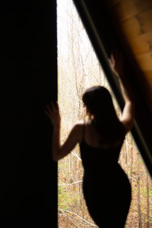 A sequence of silhouetted figures shown against a bright window, creating a dramatic shadow effect.