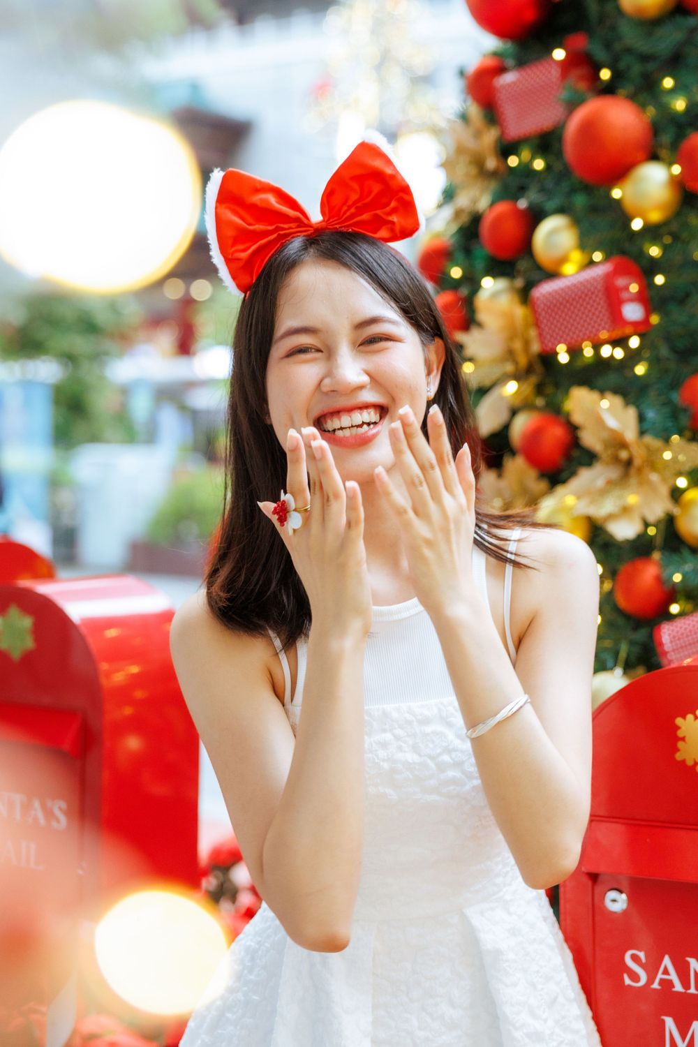 Cheerful expression captured by Santa's mailbox during Christmas photoshoot.