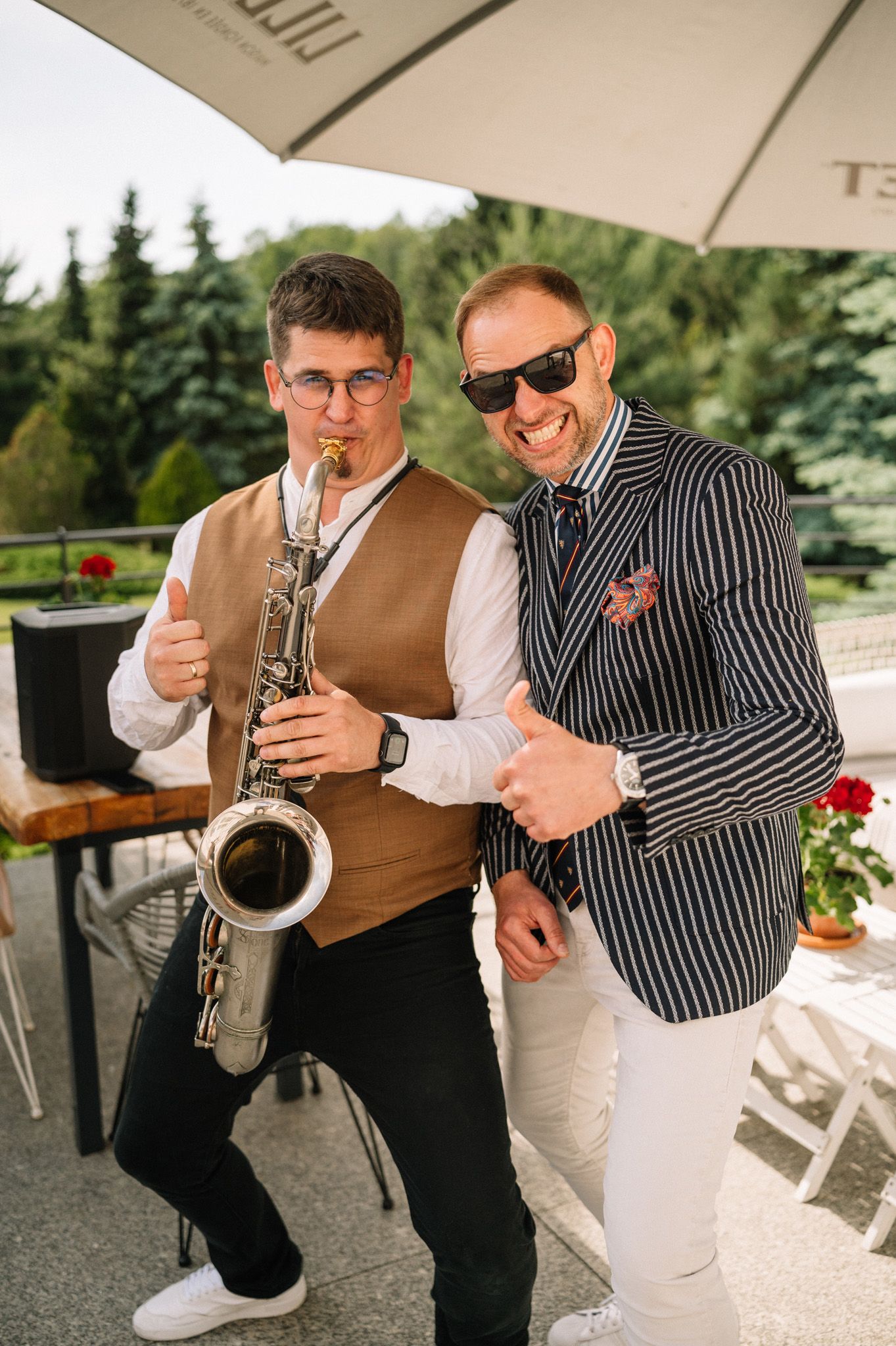 Musicians performing with saxophone at an outdoor wedding reception.