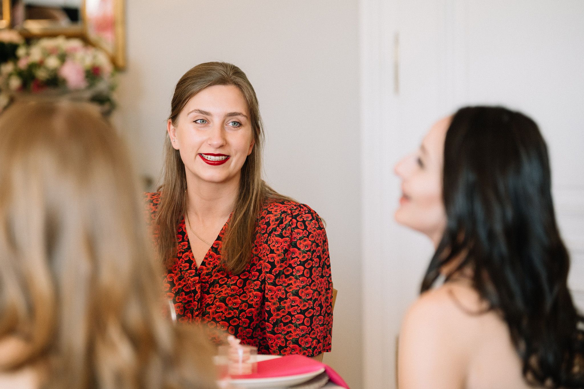 Friends engaged in animated conversation during a celebratory gathering.