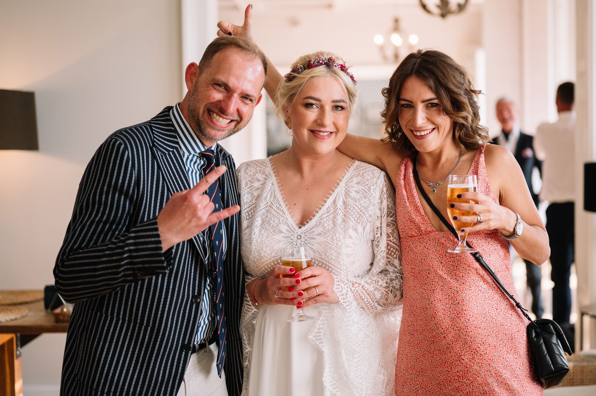 A celebration scene at a wedding reception with drinks and joyful smiles.