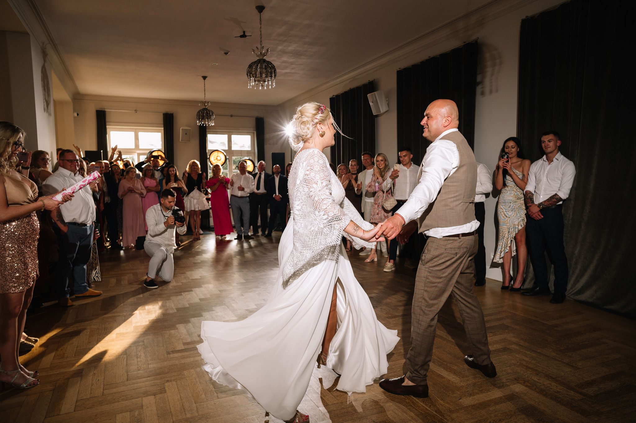 Couple sharing their first dance in an elegant indoor reception venue.