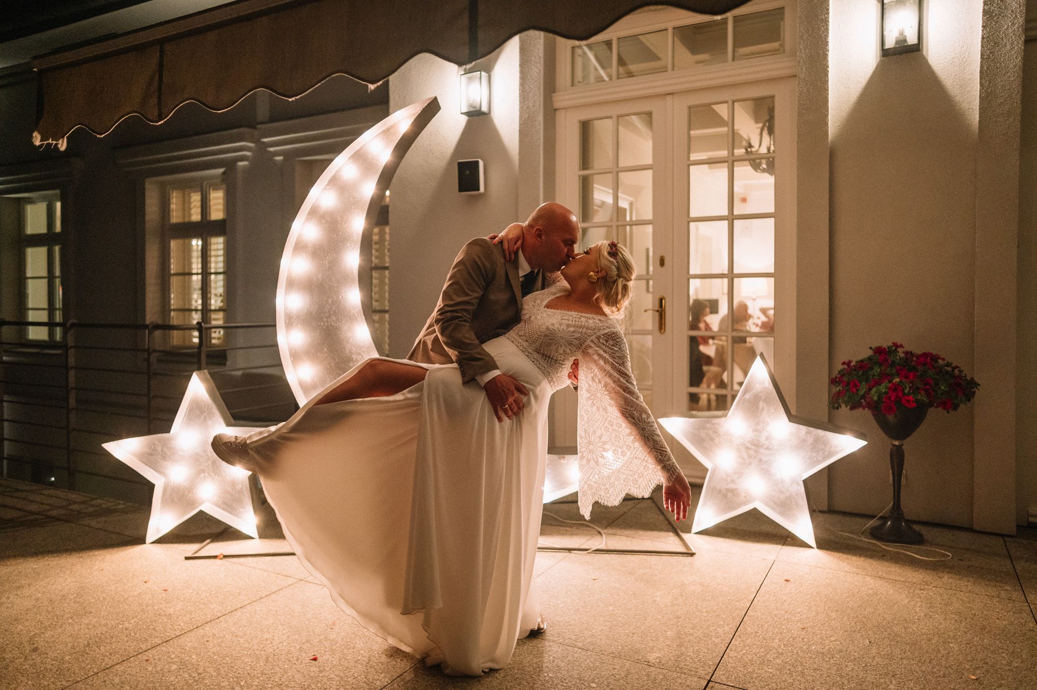 Romantic moonlit dance scene with illuminated star decorations creating a magical atmosphere.