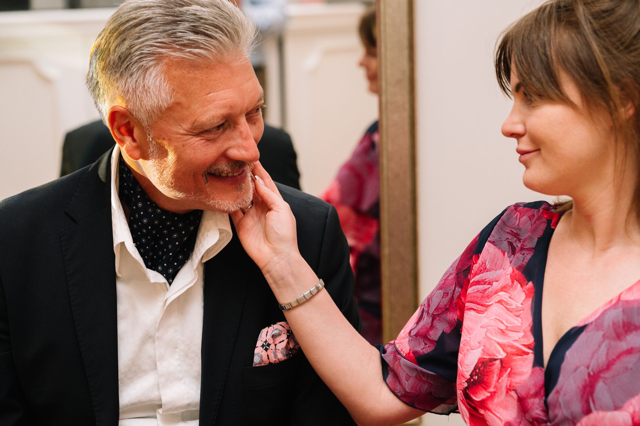 Tender moment captured between two people during a social gathering.