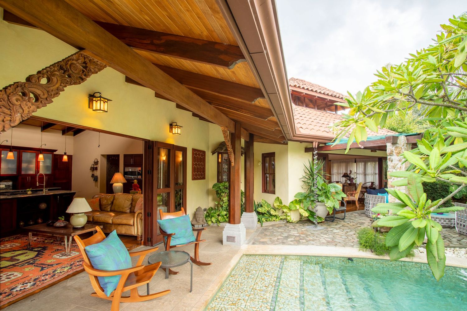 Elegant open-plan living area with modern decor and panoramic windows overlooking Costa Rica's lush landscapes