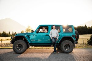 couple with their blue jeep