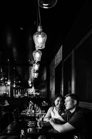 couple in a bar, girl looking the her guy