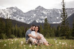 couple sitting with the mountain behind
