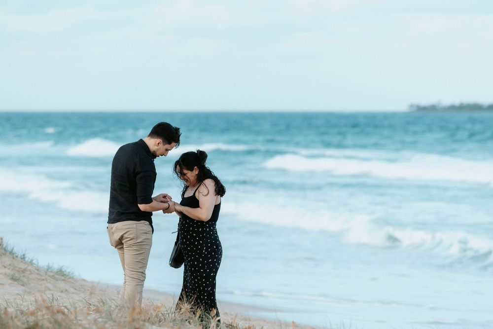 Surprise proposal photography session at sunset golden hour overlooking Mudjimba beach on the Sunshine Coast.