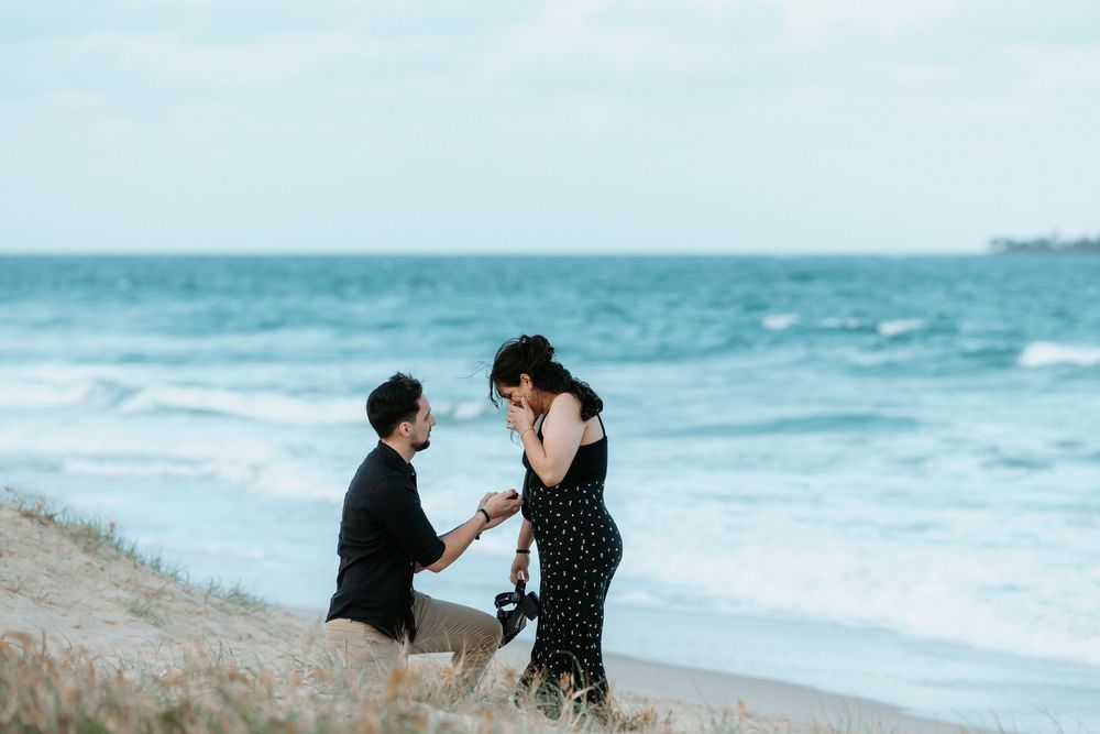Surprise proposal photography session at sunset golden hour overlooking Mudjimba beach on the Sunshine Coast.