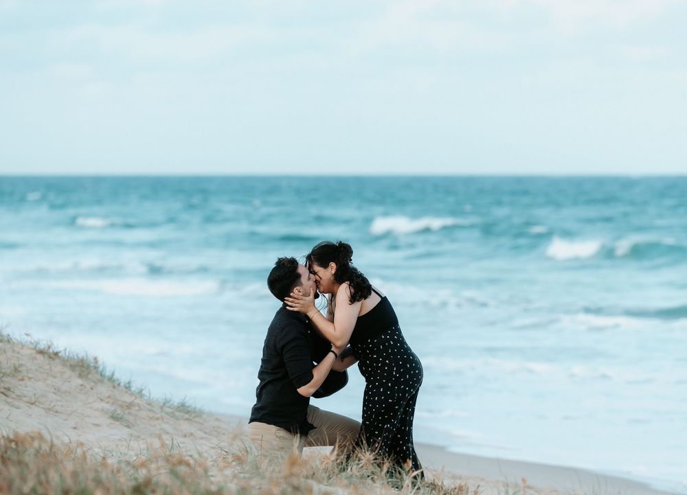 Surprise proposal photography session at sunset golden hour overlooking Mudjimba beach on the Sunshine Coast.