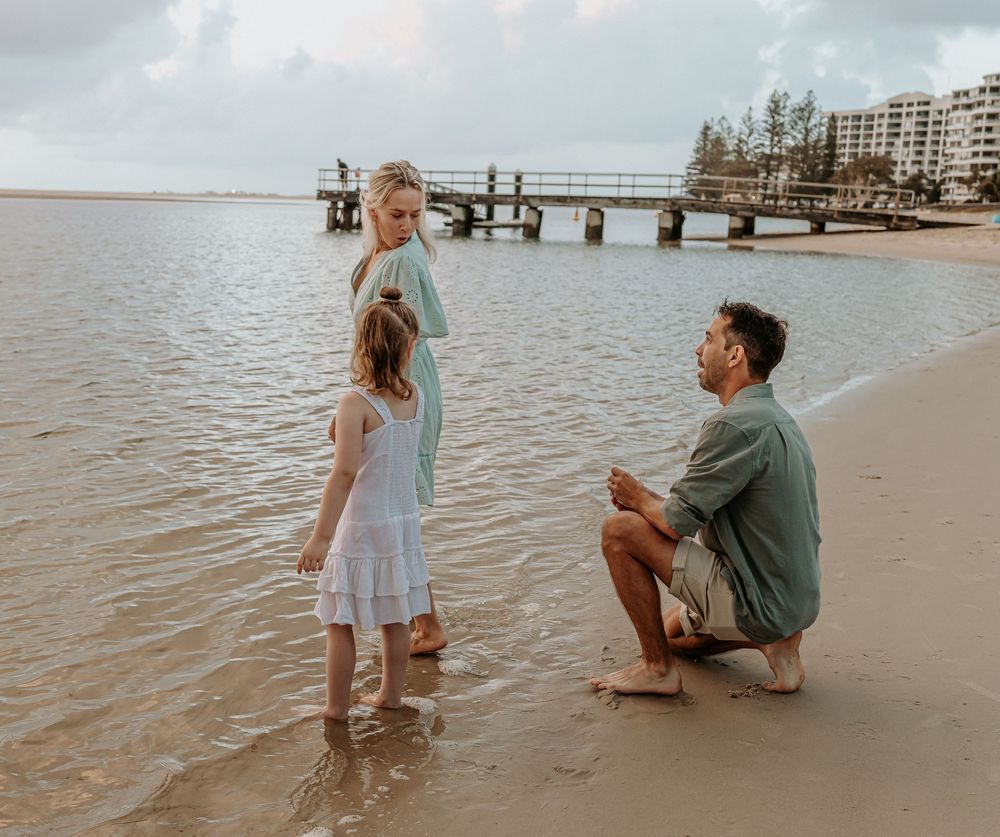 Surprise proposal photography session at sunrise golden hour overlooking Golden beach on the Sunshine Coast.