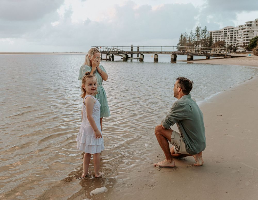Surprise proposal photography session at sunrise golden hour overlooking Golden beach on the Sunshine Coast.
