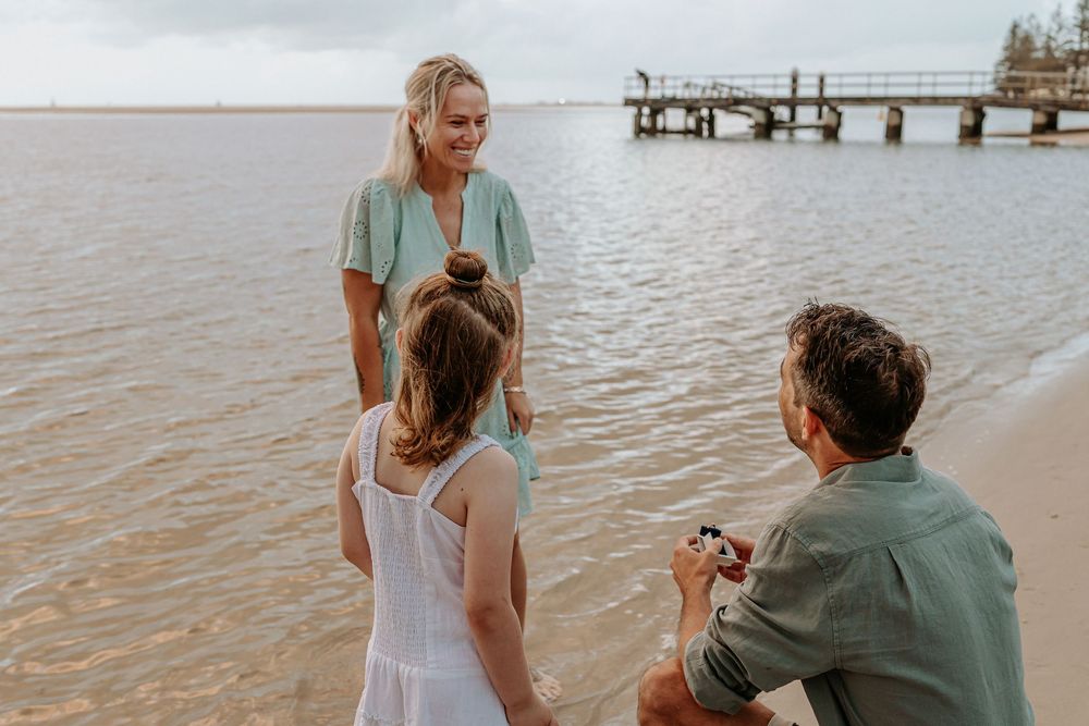 Surprise proposal photography session at sunrise golden hour overlooking Golden beach on the Sunshine Coast.