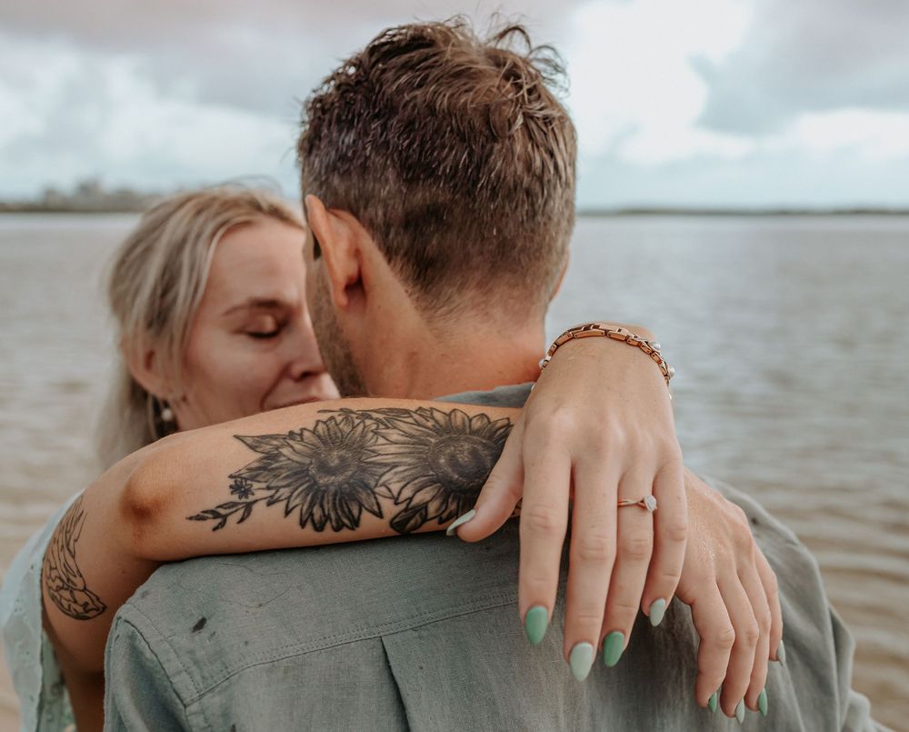 Surprise proposal photography session at sunrise golden hour overlooking Golden beach on the Sunshine Coast.