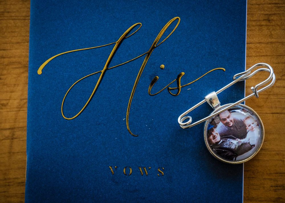 Wedding vows book with gold calligraphy on deep blue background.