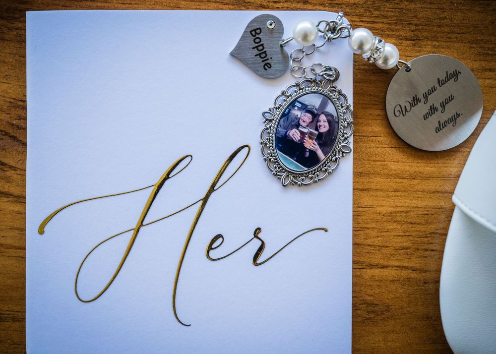 Close-up shot of elegant calligraphy on white paper with decorative elements in the background.
