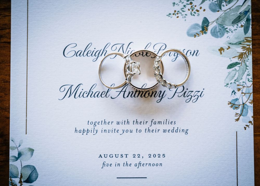Close-up shots of elegant wedding invitation with floral design and calligraphy.