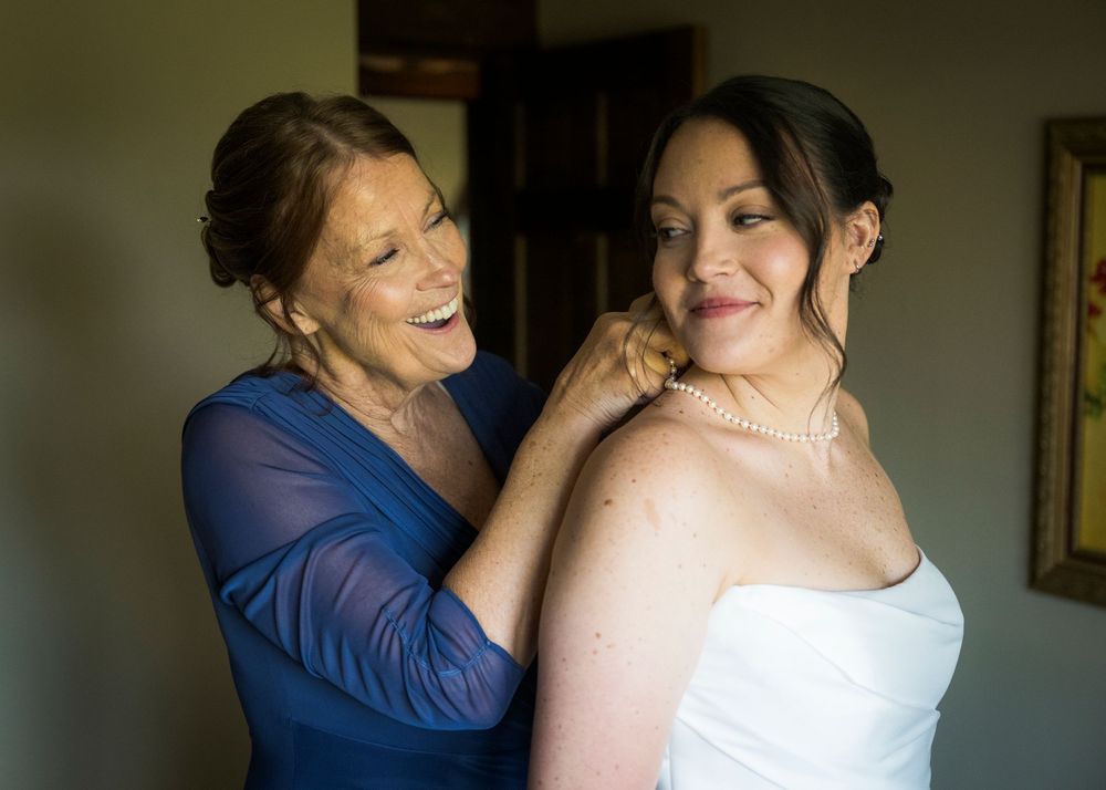 Getting ready moments captured in dramatic lighting as final preparations are made for a special occasion.