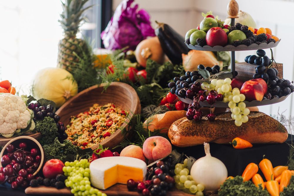 Luxurious grazing table with fresh fruits, cheeses, and nuts artfully displayed.