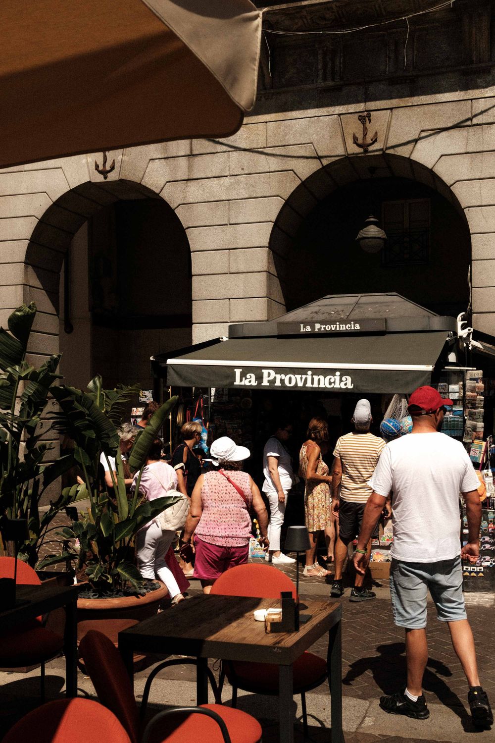 Crowds gather outside La Provincia restaurant with arched architecture and outdoor seating.