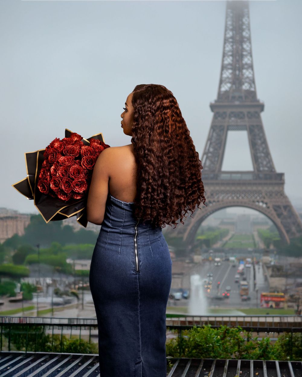 Romantic Paris scene with red roses and Eiffel Tower in misty background.