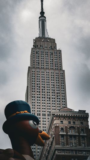 Empire State Building looms over inflatable turkey decoration in New York City.