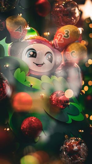 Festive holiday ornament with cartoon character design and glittery bokeh lights in the background.