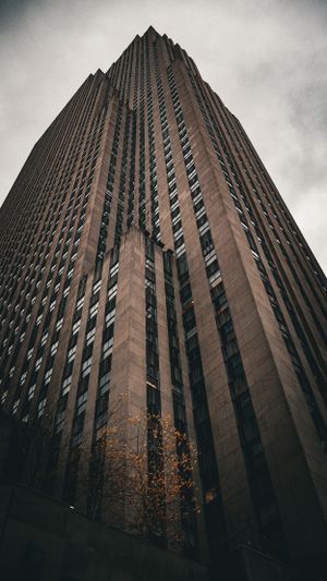 Art deco skyscraper photographed from below against a moody grey sky in New York City.