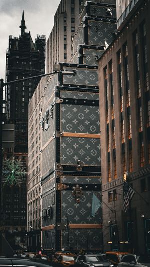 Louis Vuitton branded construction barriers line a New York City street with buildings in the background.