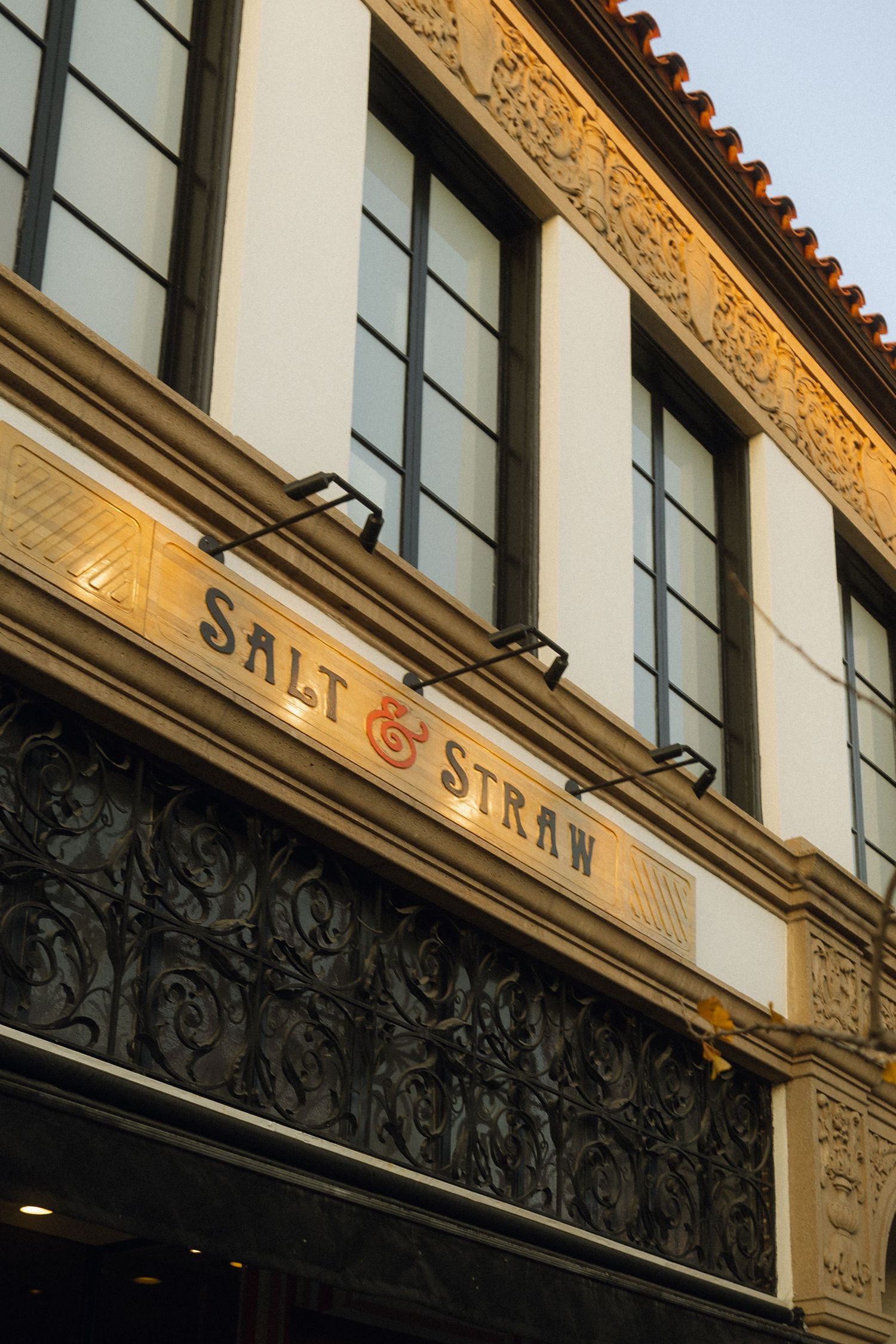 Salt & Straw storefront with ornate architectural details and large windows.